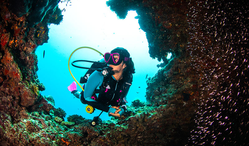 SCUBAPRO Global Dive Team Jamie Piyada diving on a coral reef