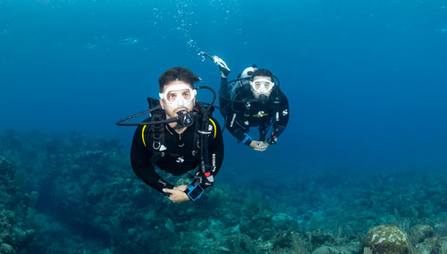 Two underwater divers wearing SCUBAPRO gear