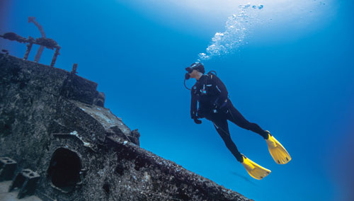 Diver underwater exploring a shipwreck