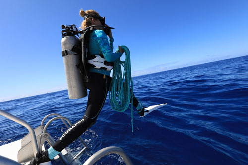 Woman diver stepping off a boat