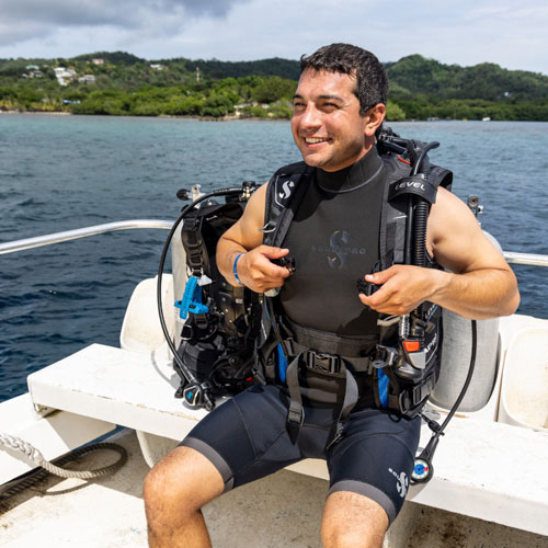 Diver sitting on a boat in SCUBAPRO gear