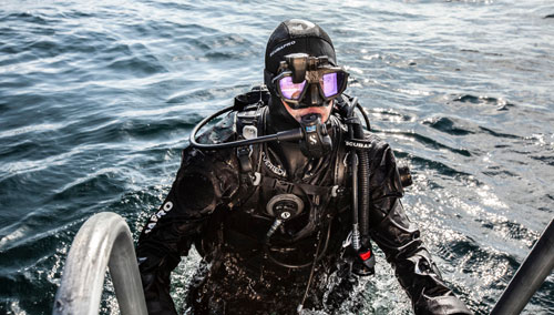 Diver climbing out of the water wearing the SCUBAPRO Evertech Dry Breathable Drysuit