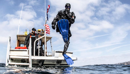 Diver stepping off a boat into the water