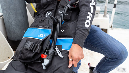 Diver on a boat folding the SCUBAPRO GO BCD