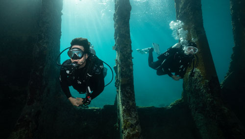 Two underwater divers exploring