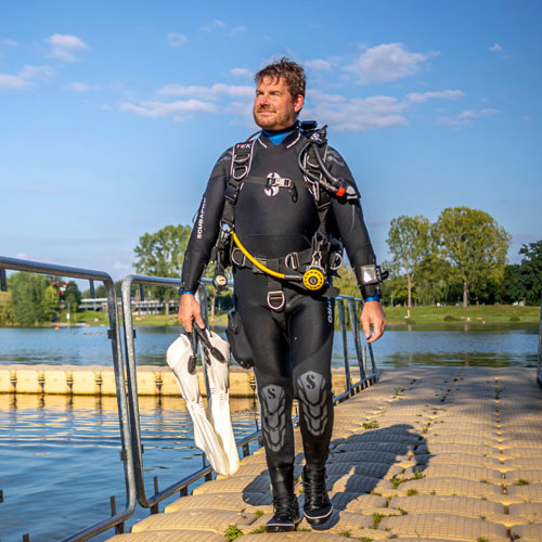 Diver on a dock wearing a SCUBAPRO NovaScotia dive suit