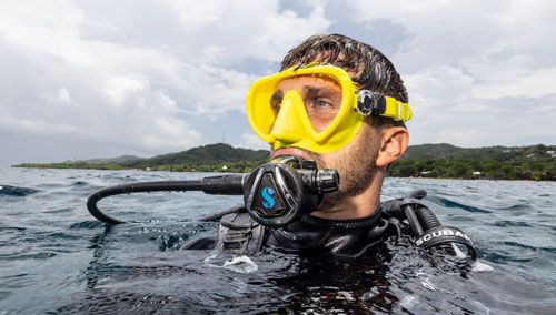 Diver's head above water wearing SCUBAPRO gear