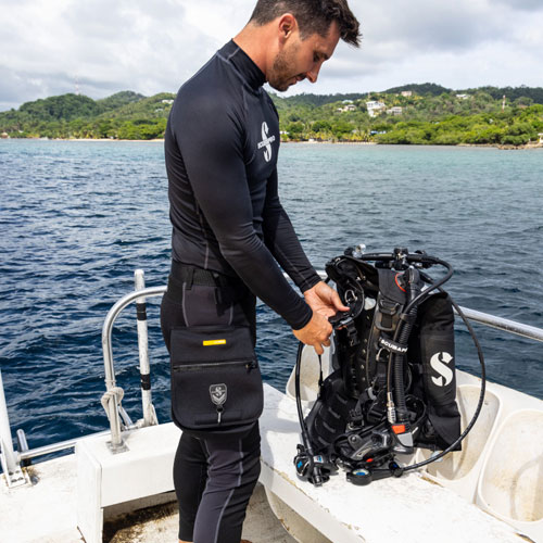 Man on a boat getting his diving gear ready