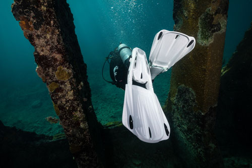 Close up of diver underwater wearing white SCUBAPRO S-Tek Modular Fin System