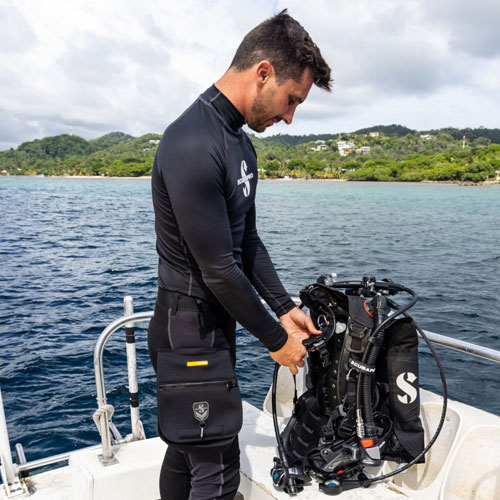 Diver on a boat getting his gear ready