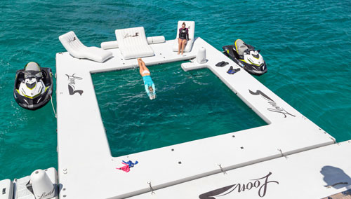 Woman diving into the ocean from a dock