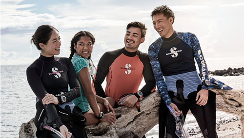 Group of snorkelers in SCUBAPRO gear on the beach