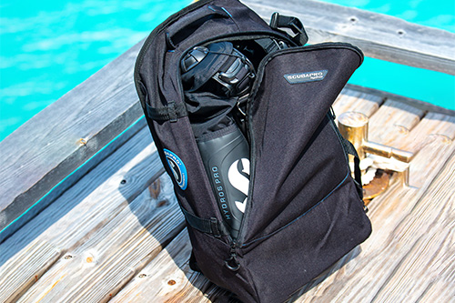 SCUBAPRO BCD Carry bag on pier beside blue water