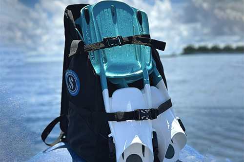 BCD Carry bag holding fins near the waterfront