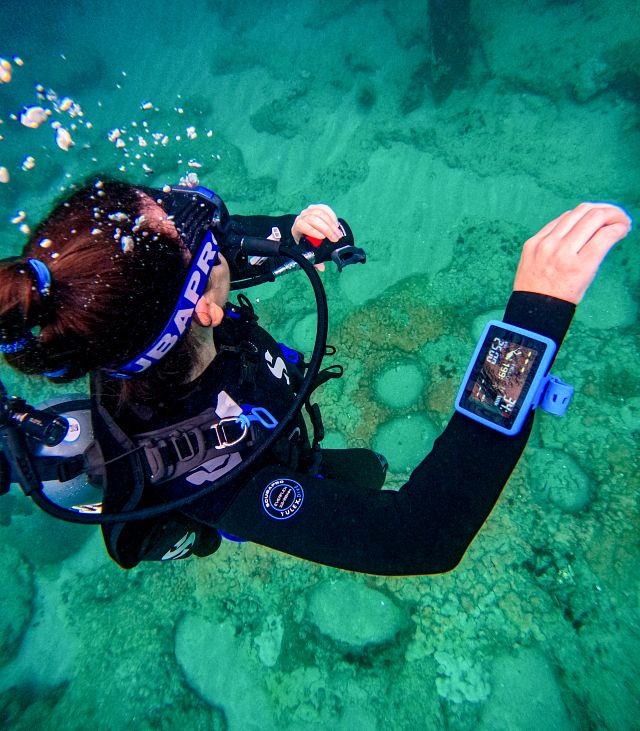 Scuba diver with a wrist mount dive computer