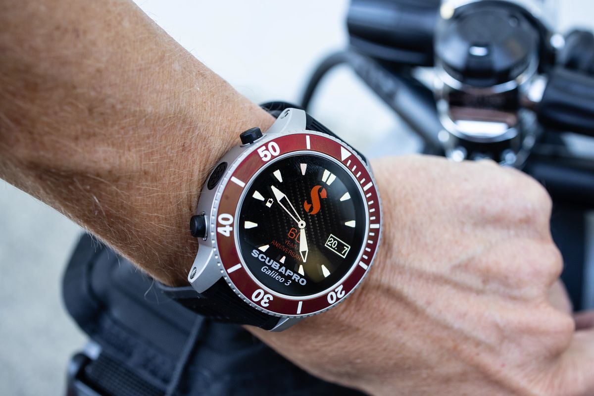 A closeup of a person wearing the Galileo 3 (G3) 60th Anniversary Editions wrist dive computer