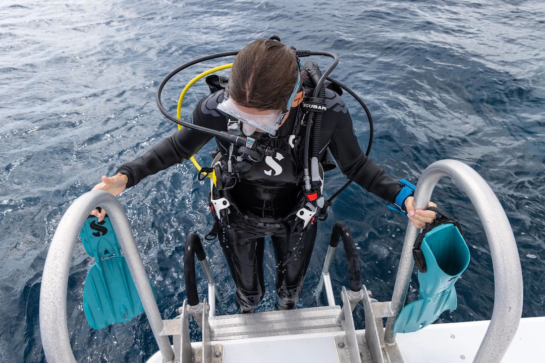 A scuba diver at the back of a boat