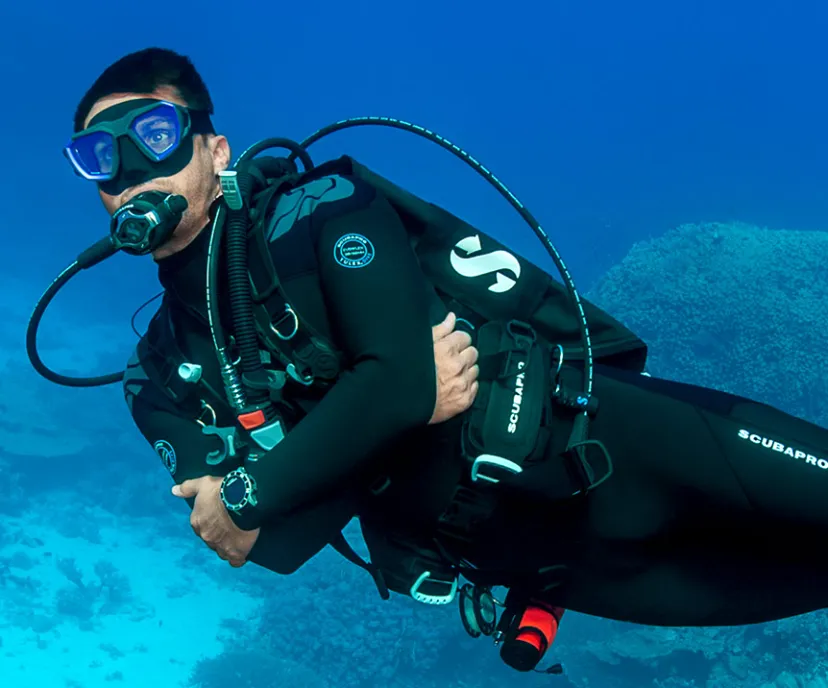 Scuba diver using Hydros Pro 2 BCD underwater near ocean floor