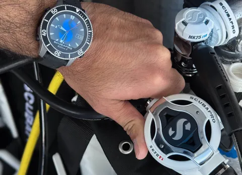 Close-up of scuba diver holding S620 Ti White Regulator