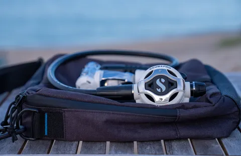 White scuba regulator on top of storage bag
